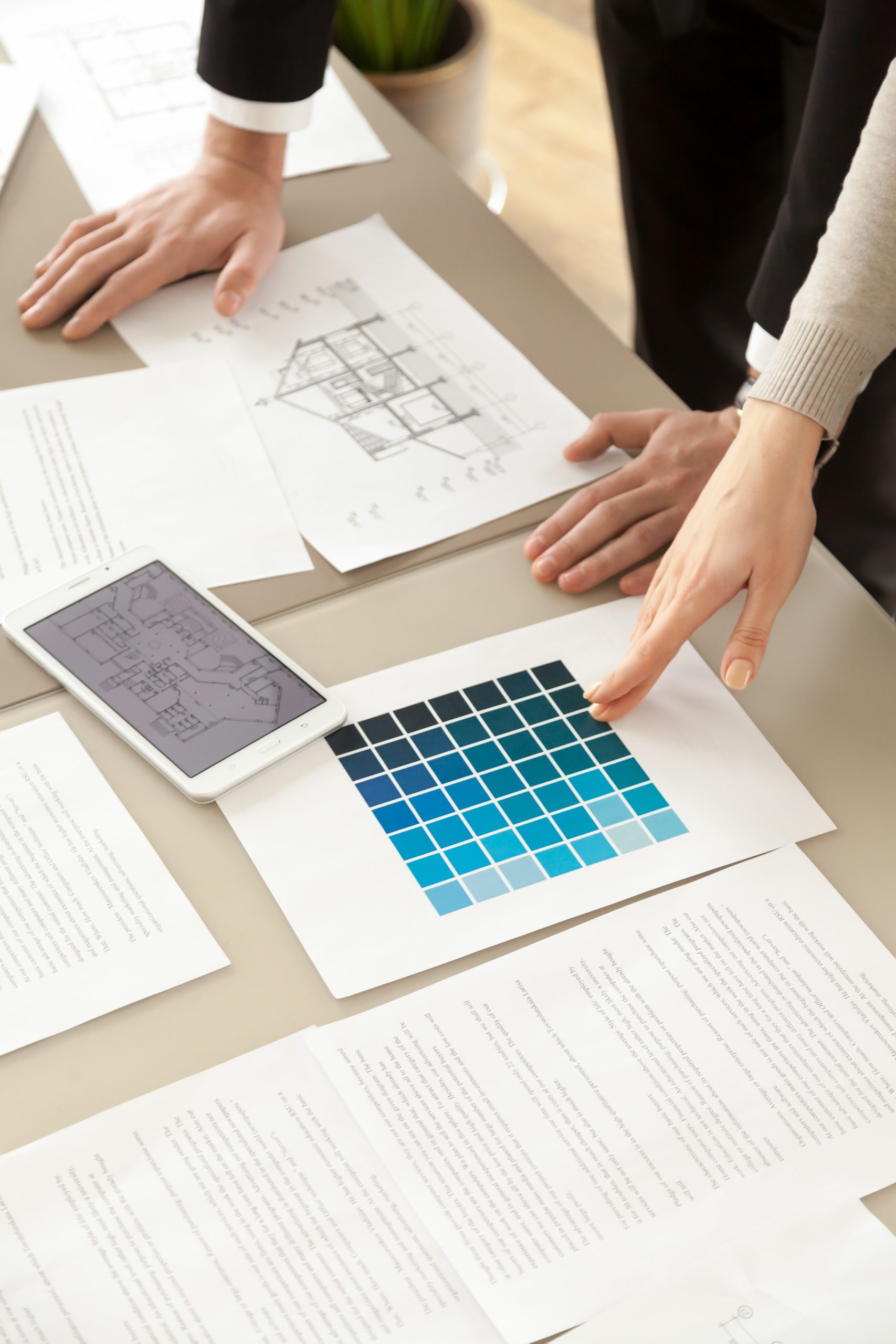 designers working on house interior with color swatches and layo
