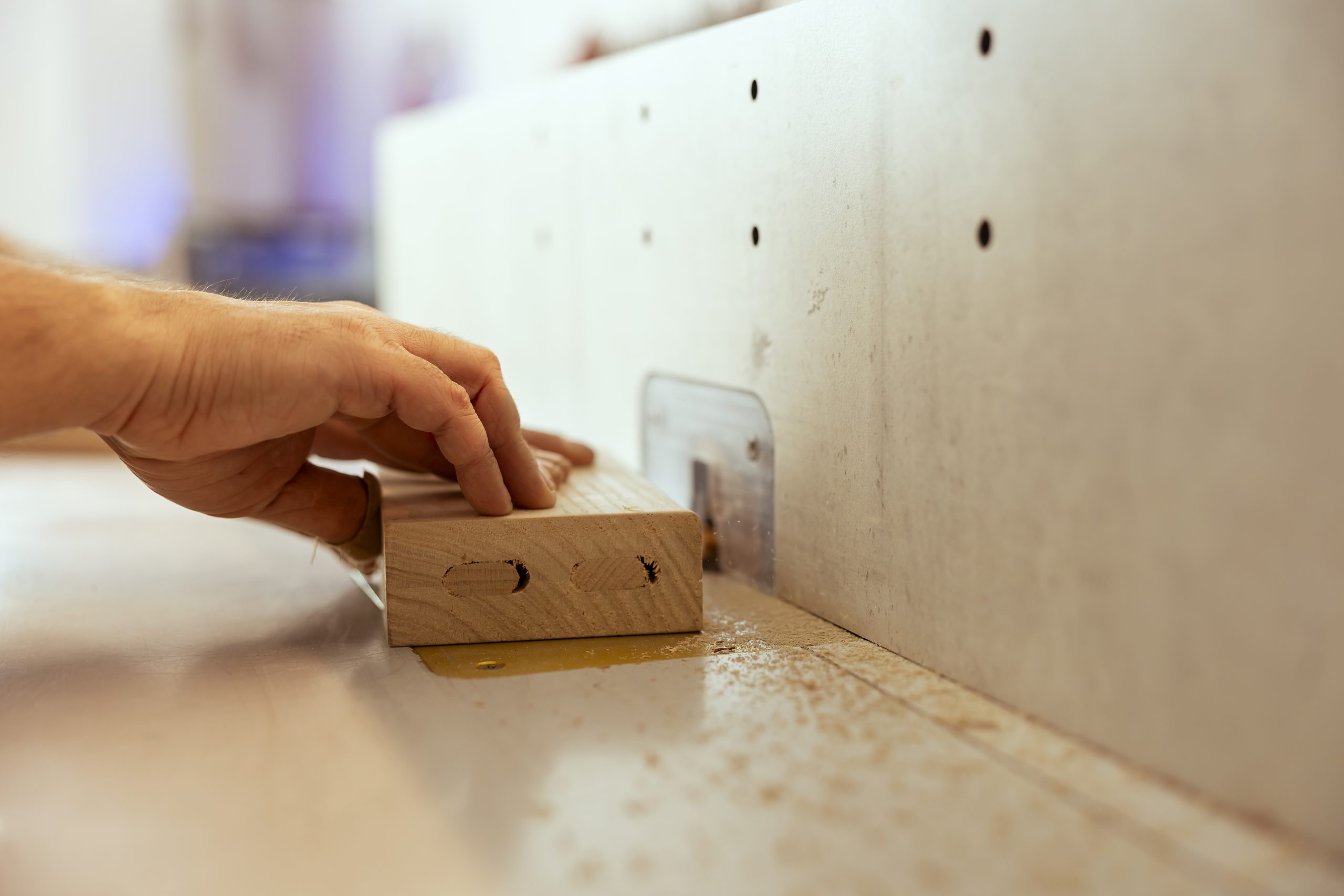 focus on wood shaper used by carpenter for smoothing out panels