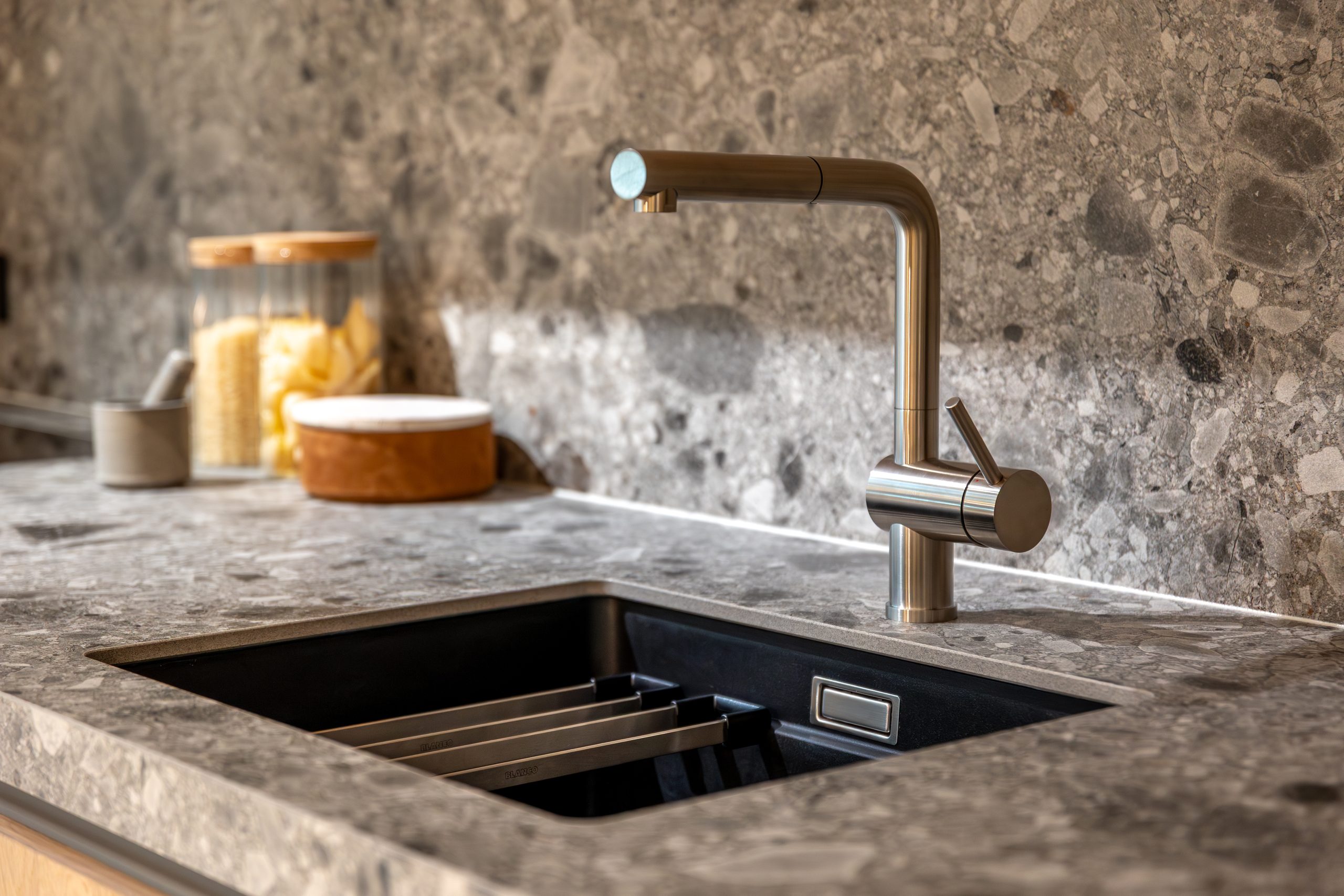 modern kitchen faucet over a granite sink. stylish and functional design.