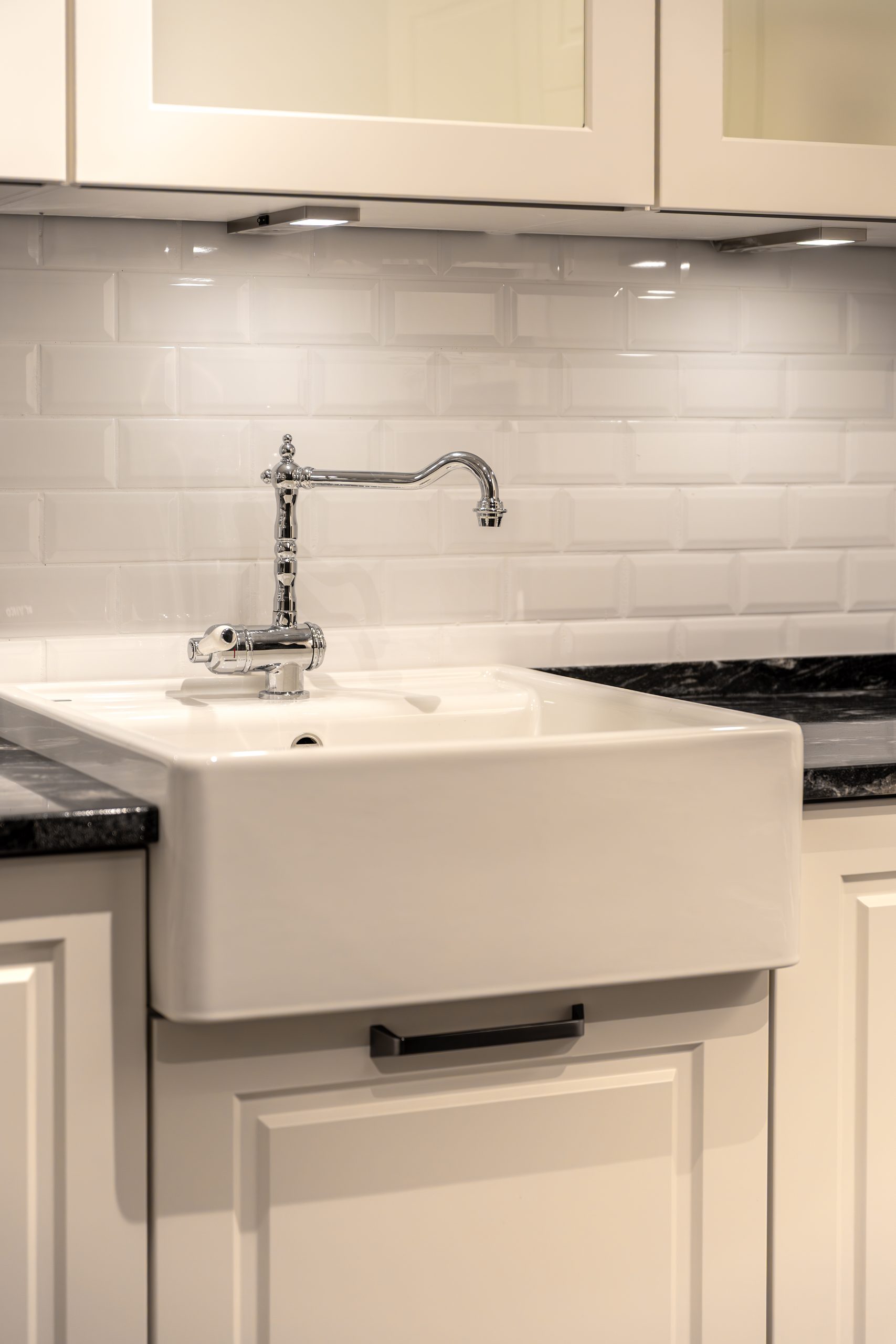 modern kitchen sink with chrome faucet. clean minimalist interior and functional kitchen design.